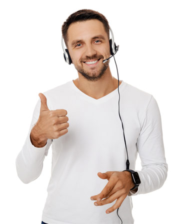 Smiling man in a white shirt and a headset, giving a thumbs-up